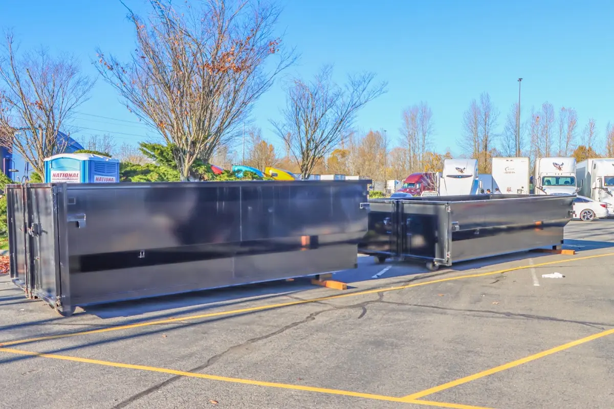 Professional dumpster rental service with roll-off container on residential driveway in Bedford Heights